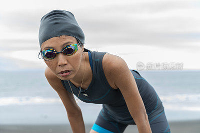 Triathlete woman coming out from sea